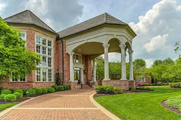 A large brick building with a porch and columns.